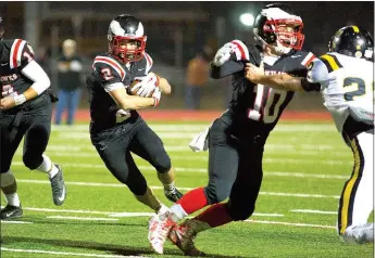  ?? Special to The TIMES ?? Blackhawk senior Gage Cawthon, No. 10, opened up a hole for Blackhawk junior running back Zaine Holley, No. 2, during the first round of state playoffs in a contest against Trumann Friday at Blackhawk Stadium.