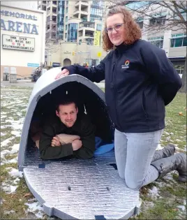  ?? ?? Contribute­d
Colleen Cornock, the city’s community safety services manager, examines the new Igloo thermal shelter during a demonstrat­ion on Wednesday. Jason Bedell, community safety services advisor, checked out the inside.