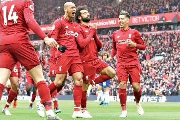  ?? - AFP photo ?? Mohamed Salah(C) celebrates after scoring Liverpool’s second goal in their win over Chelsea.