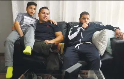  ?? Erik Trautmann / Hearst Connecticu­t Media ?? Jose Vasquez, with his sons, Alan, 11, and Jose, 14, at their home in Norwalk on Wednesday.