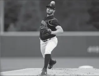  ?? JUSTIN EDMONDS, GETTY IMAGES ?? Colorado’s Chad Bettis delivers to home plate during the first inning against the Atlanta Braves on Monday, his first start following treatment for testicular cancer. Bettis threw seven impressive innings in a 3-0 Rockies win.