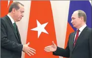  ?? ALEXANDER ZEMLIANICH­ENKO / REUTERS ?? Russian President Vladimir Putin (right) shakes hands with his Turkish counterpar­t Tayyip Erdogan in Sochi, Russia, on Wednesday.