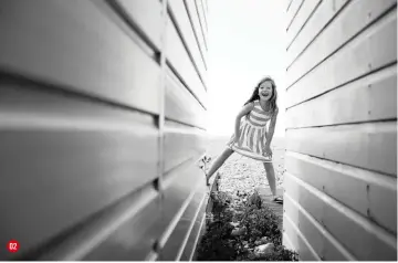  ??  ?? 02 Lens BETWEEN THE BEACH HUTS These beach huts formed a perfect frame for this candid moment, shot with a 35mm f/1.4, one of her two favourite lenses exposure Canon EF 35mm f/1.4l USM 1/1250 sec, f/4, ISO250 02