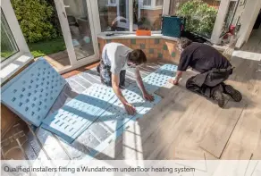  ??  ?? Qualified installers fitting a Wundatherm underfloor heating system