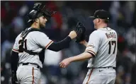  ?? RON SCHWANE — GETTY IMAGES ?? Catcher Joey Bart and reliever Jake McGee congratula­te each other after the Giants' 4-2 win over the Guardians on April 16.