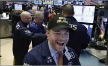  ?? RICHARD DREW — THE ASSOCIATED PRESS ?? Specialist Frank Masiello wears a Dow 20,000 cap as he works on the floor of the New York Stock Exchange, Wednesday. The Dow Jones industrial average is trading over 20,000 points for the first time, the latest milestone in a record-setting drive for...