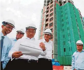  ?? PIC BY RAMDZAN MASIAM ?? Minister in the Prime Minister’s Department Datuk Seri Abdul Rahman Dahlan (third from left) visiting a low-medium-cost housing project in Sungai Nibong, Bayan Baru.