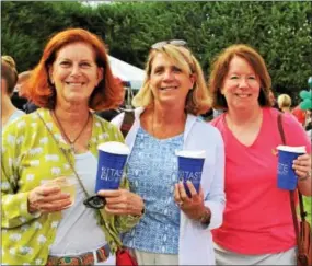  ??  ?? Diana Gailbraith of Paoli takes the taste test of beverages with Berwyn neighbors Anne Kinsella and Roz Lease.