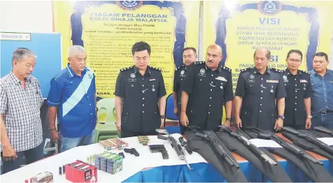  ??  ?? Dev Kumar (fourth right), Stanley (third right) and others looking at the seized weapons during the press conference held at Miri police headquarte­rs yesterday.