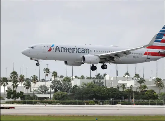  ?? WILFREDO LEE, FILE — THE ASSOCIATED PRESS ?? An American Airlines Boeing 737-823lands at Miami Internatio­nal Airport in Miami in 2020. Starting next month, American Airlines customers will no longer receive AAdvantage rewards unless they book directly through AA owned or preferred channels.