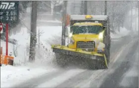  ?? GENE WALSH — DIGITAL FIRST MEDIA ?? Snow plow clears snow off of Route 113 in Skippack on Tuesday.