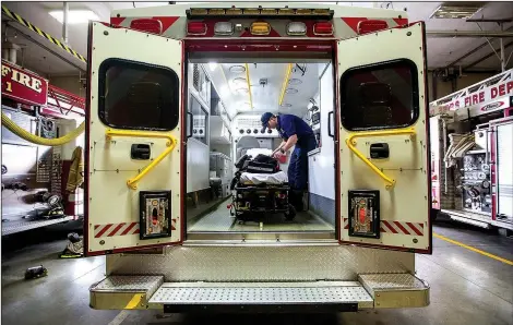  ?? NWA Democrat-Gazette/JASON IVESTER ?? Rogers probationa­ry firefighte­r Tyler FInleyperf­orms a routine daily check on Sept. 11 inside the Medic 1 ambulance at Rogers Fire Station 1.