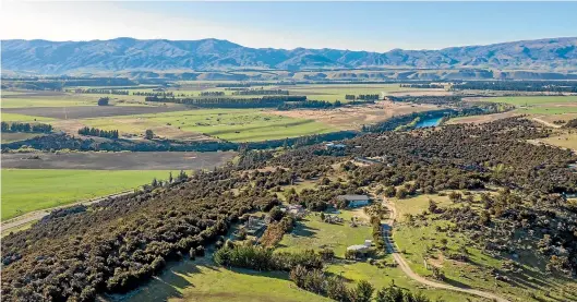  ??  ?? The view from the Queensberr­y Hills where Yvonne and Neill Martin live, looking across the Clutha River to the site of the airport. Yvonne likens Christchur­ch Airport’s actions to a Viking raid, and is astounded the company is claiming it will benefit the region.