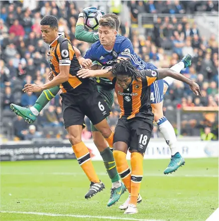  ??  ?? ■ Hull defender Curtis Davies (left) and forward Dieumerci Mbokani win an aerial battle with Gary Cahill.