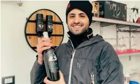  ?? ?? Winemaker Mattia Muggittu with a bottle of his Boeli wine. Photograph: Mattia Muggittu