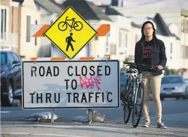  ?? Paul Chinn / The Chronicle ?? Janice Li of the SF Bicycle Coalition at a Slow Streets barricade on 41st Avenue in the Sunset District.