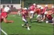  ?? JOHN KAMPF — THE NEWS-HERALD ?? Perry quarterbac­k Drew Schiano pitches to Cameron Rogers during the Pirates’ scrimmage with North on Aug. 11.