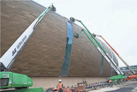  ?? MICHAEL SEARS/MILWAUKEE JOURNAL SENTINEL ?? Work continues on the exterior of the new arena as the interior takes shape.