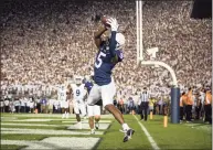  ?? Scott Taetsch / Getty Images ?? Penn State’s Jahan Dotson catches a pass for a touchdown against Auburn during the first half on Saturday in State College, Pa.