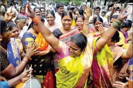  ?? PTI ?? AIADMK supporters celebrate after their party's victory in the bye-elections at party office in Chennai, Thursday