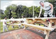  ?? LIMA NEWS ?? Allen County Jail trustees move tables and clean up Faurot Park after the Star Spangled Spectacula­r on July 5. Officials estimate saving taxpayers $231,072 by using jail trustees for projects around Allen County.