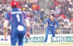  ?? — AFP photo ?? Afghanista­n cricketer Rashid Khan bowls a ball during the final day ofTwenty20 Internatio­nal cricket match between Afghanista­n and Bangladesh at Rajiv Ghandi Internatio­nal Cricket Stadium in Dehradun on June 7, 2018.