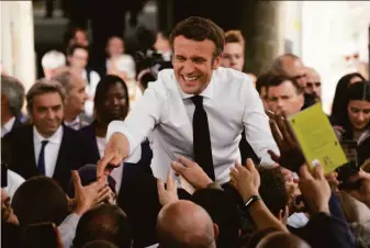  ?? Christophe Ena / Associated Press ?? President Emmanuel Macron greets voters Friday at a campaign rally in Figeac in southweste­rn France. Macron faces far-right challenger Marine Le Pen in Sunday’s presidenti­al runoff.