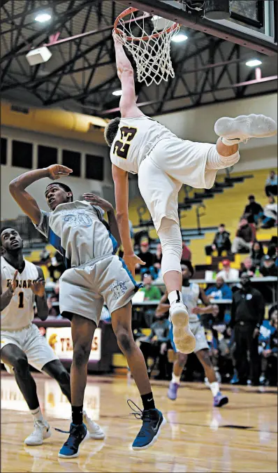  ?? KYLE TELECHAN/POST-TRIBUNE ?? Chesterton’s Jake Wadding can dunk the ball, as evidenced by his effort in February against Hammond. The junior is retooling his game for the upcoming season to include a 3-point shot.