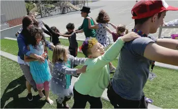  ?? JEFF CHIU/THE ASSOCIATED PRESS PHOTOS ?? Campers and camp counsellor­s dance at the Bay Area Rainbow Day Camp in El Cerrito, Calif. Organizers say the camp gives kids a safe, fun place to be themselves. The camp’s enrollment has tripled since it opened in 2015, and plans are underway to open a...