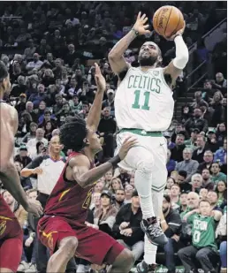  ?? Elise Amendola / Associated Press ?? Boston’s Kyrie Irving shoots over Cleveland’s Collin Sexton on Friday. Irving scored his 29 points in the first three quarters.