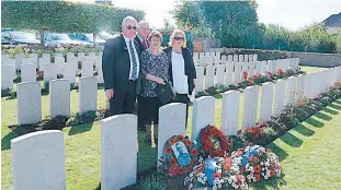  ??  ?? Four great nephews and nieces of Private Charles Eacott, killed on the Western Front in Belgium in 1917, but whose grave was unknown until last year, attended the recent naming and rededicati­on of his grave at Birr Cross Roads Cemetery in Belgium. Standing at the graveside after the formal ceremony are, from left, Bill and Allan Eacott, Sandra Johnston (nee Watson) and Jennifer Murnane (nee Eacott).