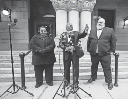  ?? MIKE DE SISTI / MILWAUKEE JOURNAL SENTINEL ?? City Attorney Tearman Spencer, center, speaks alongside Ald. Milele Coggs, left, and deputy city attorney Robin Pederson outside the federal courthouse in Milwaukee on Wednesday.