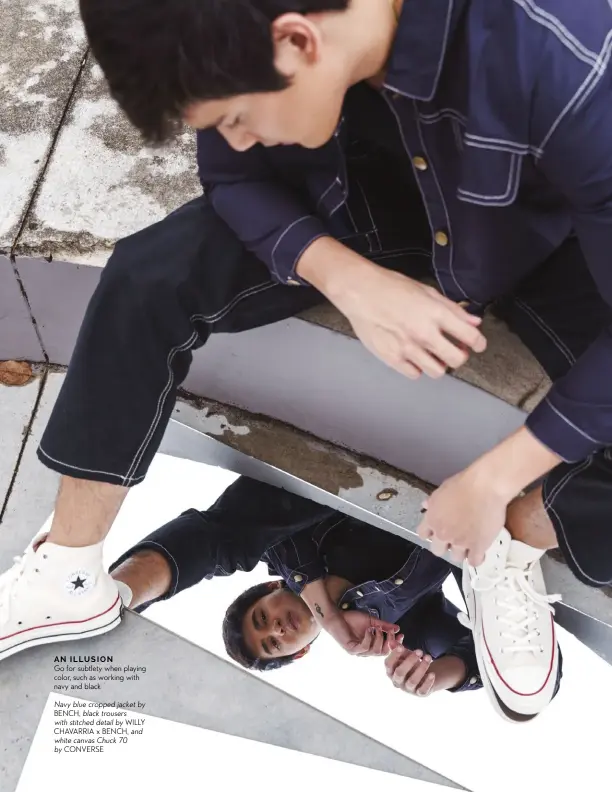  ??  ?? AN ILLUSION
Go for subtlety when playing color, such as working with navy and black
Navy blue cropped jacket by BENCH, black trousers with stitched detail by WILLY CHAVARRIA x BENCH, and white canvas Chuck 70 by CONVERSE