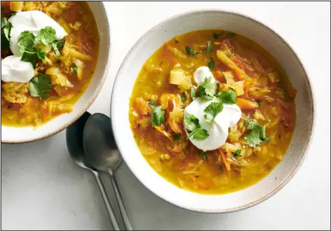  ?? PHOTOS BY DAVID MALOSH — THE NEW YORK TIMES ?? A generous dollop of sour cream or yogurt makes this golden beet borscht nice and silky.
3. Discard thyme sprigs and Parmesan rinds. Using a Microplane or other fine grater, grate in the zest from the lemon. Stir in grated Parmesan and dill.
4. Halve the lemon and squeeze in the juice from half of it. Cut the remaining lemon half into wedges for serving. Taste soup and add more salt and pepper, if needed. To serve, ladle into soup bowls, and garnish with more grated cheese, a lemon wedge and more redpepper flakes, if you like.