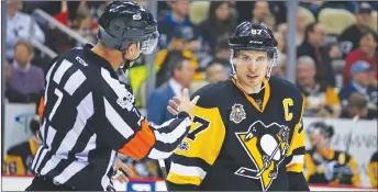  ?? AP PHOTO ?? Sidney Crosby listens to referee Garrett Rank during a game against the Detroit Red Wings in Pittsburgh.