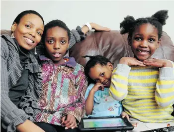  ?? BRUCE EDWARDS/EDMONTON JOURNAL ?? Emily Khalema with her children, from left, Thandi. 11, Natal. 2, and Dineo. 6