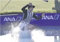  ?? AFP ?? Thailand’s Patty Tavatanaki­t jumps into the Poppie’s Pond after winning the ANA Inspiratio­n at Mission Hills Country Club in April.
