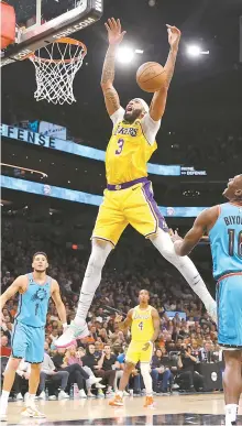  ?? AFP-Yonhap ?? Anthony Davis, top, of the Los Angeles Lakers loses the ball as he attempts a shot against the Phoenix Suns during the second half of the NBA game at Footprint Center in Phoenix, Ariz., Tuesday.