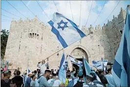  ?? LIOR MIZRAHI/GETTY ?? Israelis celebrate Sunday during a march outside Damascus Gate in Jerusalem. Israel marked Jerusalem Day, the 51st anniversar­y of what it calls the city’s unificatio­n.