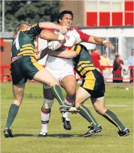  ??  ?? KEEP DRIVING FORWARD: Picture from the Hull KR v Doncaster Lakers game at Craven Park in east Hull in 2006, with David Tangata-toa making an attempt in the first half to drive through the Lakers defence, the score at this point was 10- 18.