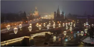  ?? (AP/Alexander Zemlianich­enko) ?? The Kremlin Wall, the Spasskaya Tower, Red Square, the GUM department store, the St. Basil’s Cathedral and the Bolshoy Moskvorets­ky Bridge are decorated for Christmas and the New Year festivitie­s Dec. 12 in Moscow.