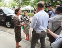  ?? Ernest A. Brown photo ?? Upon her arrival at an event at Park View Manor in Woonsocket Friday afternoon, Gov. Gina Raimondo, left, faces questions from the media about the PawSox announceme­nt that they are leaving Rhode Island for Worcester.