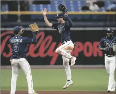  ?? AP PHOTO/CHRIS O’MEARA ?? Tampa Bay Rays center fielder Brett Phillips, center, celebrates with shortstop Wander Franco (left) and right fielder Vidal Brujan (right) after the team defeated the Detroit Tigers during a baseball game on Wednesday in St. Petersburg, Fla.