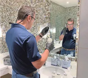  ?? ELIZABETH WEISE/USA TODAY ?? IWC Innovation­s’ Brian Waymire tests the Ahern Hotel’s water. “Calls have been through the roof” for his staff to help buildings reopen.