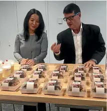  ?? GERALD HUTCHING/STUFF ?? Fonterra Greater China president Christina Zhu and communicat­ions manager Graeme McMillan with a spread of muddy buns.