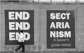  ??  ?? A mural saying ‘End Sectariani­sm’ is seen on the Falls Road in Belfast, Northern Ireland . — Reuters photo