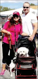  ?? RITA GREENE/
MCDONALD COUNTY PRESS ?? Joe and Marcela Keiser of Bella Vista brought ‘Precious’ who preferred riding to walking, and their other pet, Kirby, to the Oktoberfes­t Saturday at Pineville Square.
