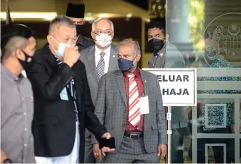  ?? — Bernama photo ?? Najib exits the court complex at the end of proceeding­s.