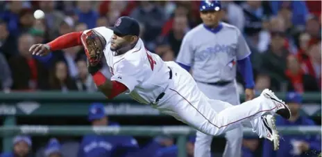  ?? JIM ROGASH/GETTY IMAGES ?? Boston’s Pablo Sandoval makes a nice leaping catch off a Dalton Pompey line drive during action Monday night at Fenway Park.