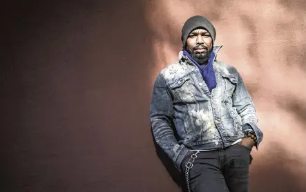  ?? BEBETO MATTHEWS AP ?? Painter Guy Stanley Philoche, a 43-year-old Haitian immigrant and star in the New York art world, relaxed outside his New York studio in November. After a hugely successful gallery show, Philoche bought the works of fellow artists struggling in the pandemic.